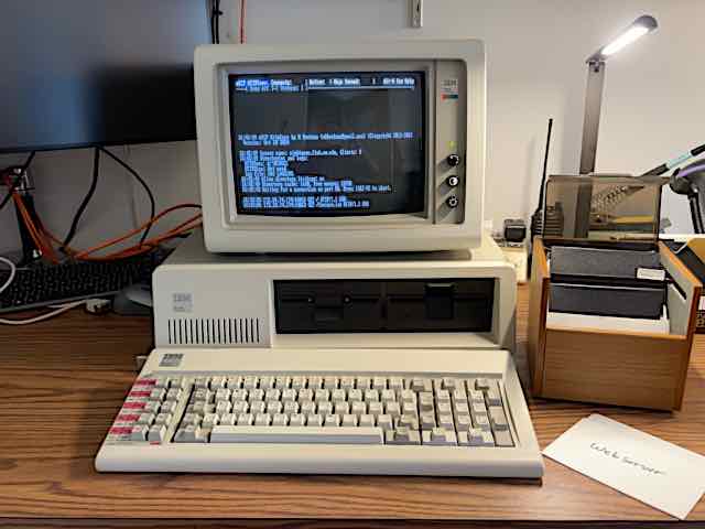 An IBM PC model 5150 with model 5153 Color 
Display sitting on a desk. mbrutman's mTCP HTTPSERV is running on it, serving 
this page.